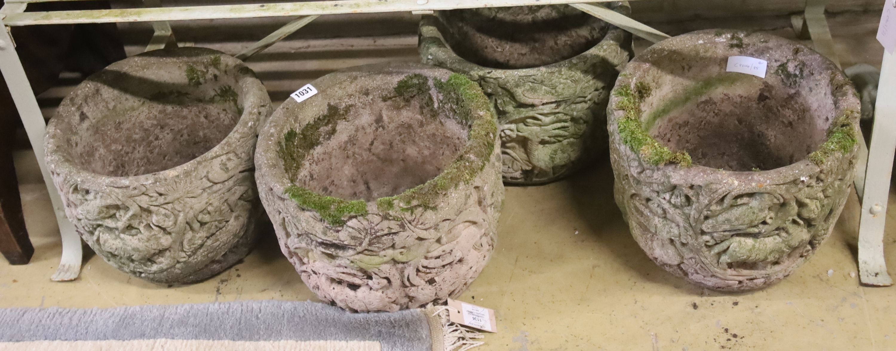 A set of four circular reconstituted stone garden planters, 30cm diameter, height 24cm